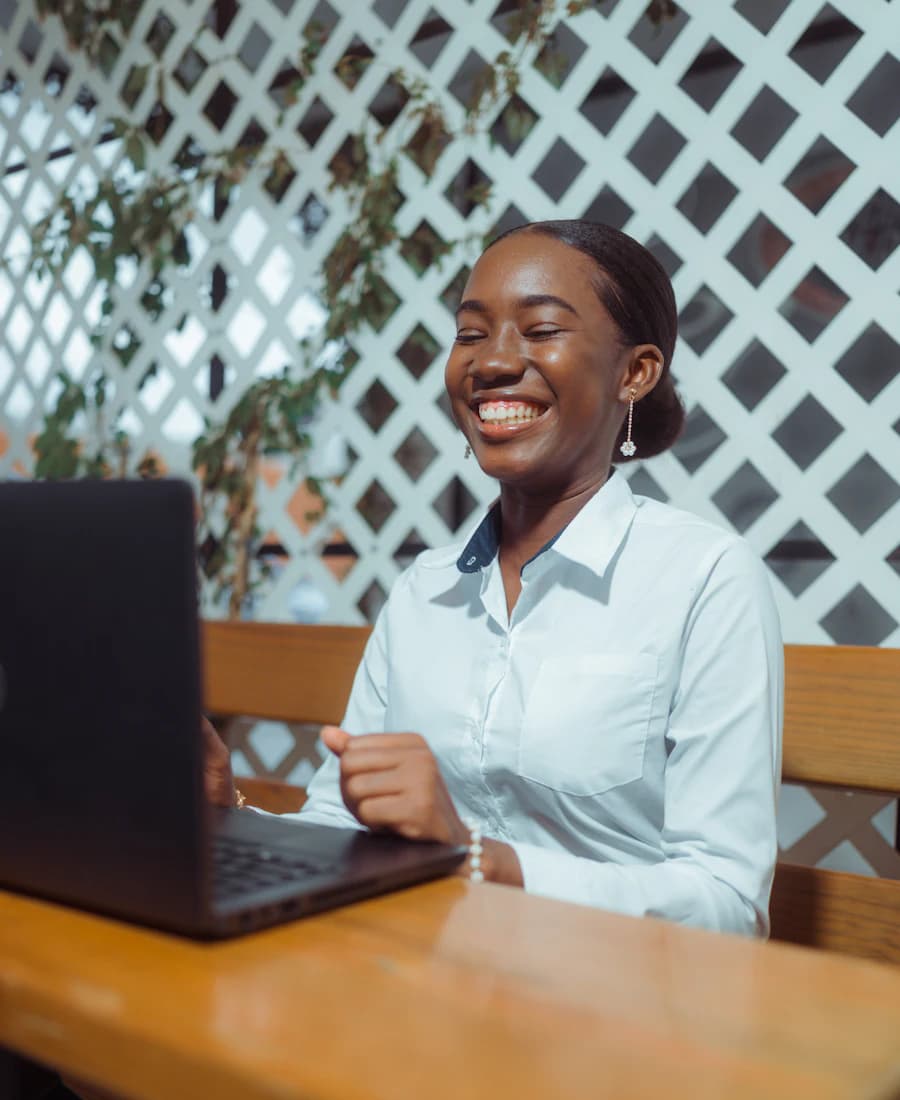 A recruiter smiling while working on her laptop